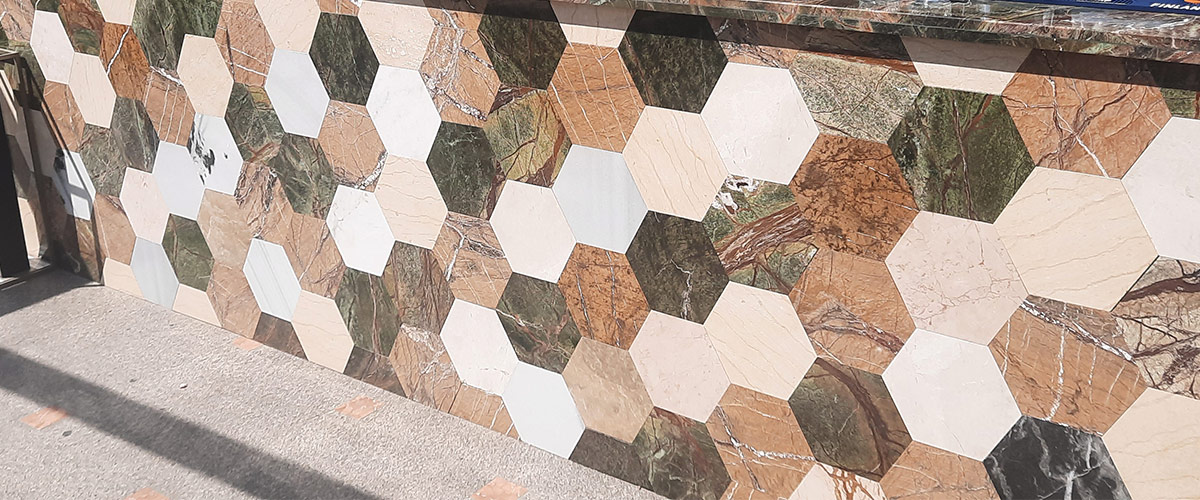 mix-hexagoane-marmura-travertin-granit fotografie in exterior cu un bar facut din hexagoane de piatra naturala